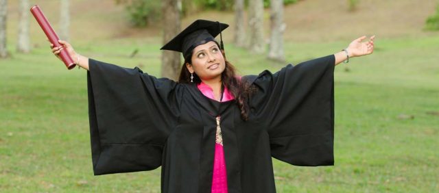 south asian female graduate with green background
