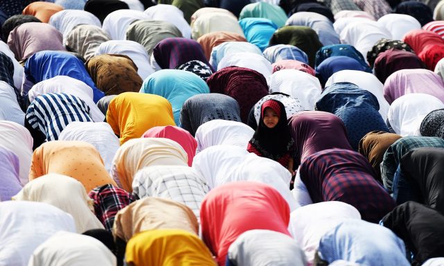 Muslim people offer Eid al-Adha prayers