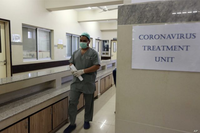 A Pakistan doctor enters an isolation ward set up as a preventative measure following the deadly Coronavirus outbreak, at the Jinnah Postgraduate Medical Center in Karachi, Pakistan, Monday, Feb. 3, 2020. Precautionary measures have been tightened around the country following the report of the first death of a new virus outside of China. (AP Photo/Fareed Khan)