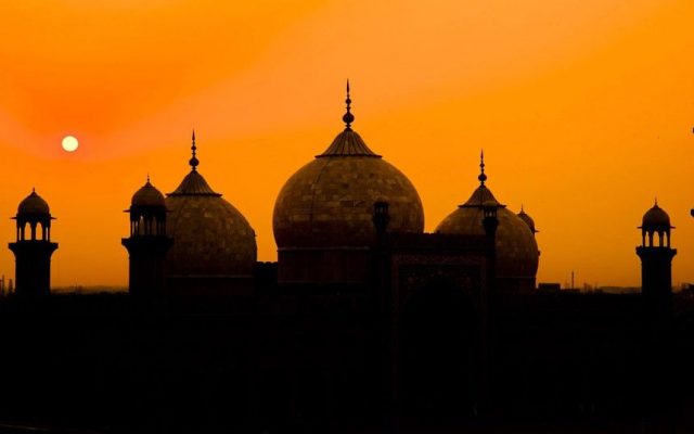 sun sets behind the Badshahi Mosque