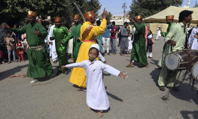 A boy performs traditional dance with others during a rally to celebrate the birthday of Islam's Prophet, Muhammad, in Karachi, Pakistan, Sunday, Nov. 10, 2019. To mark the holiday thousands of Pakistani Muslims take part in religious processions,