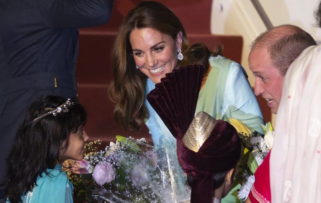 Britain's Prince William and his wife Kate receive flowers from a child upon their arrival at the Nur Khan base in Islamabad, Pakistan, Monday, Oct. 14, 2019. They are on a five-day visit, which authorities say will help further improve relations between the two countries.