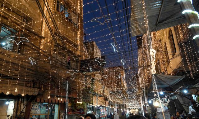 People-walk-in-decorated-street-to-mark-the-birthday-celebration-of-the-Prophet-Muhammad-in-Lahore