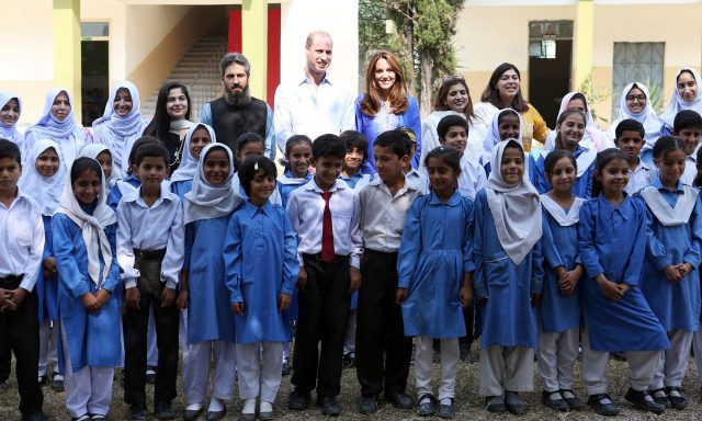 Britian's Prince William and Catherine, Duchess of Cambridge pose for a group photo with staff and students at a school during a trip to Islamabad, Pakistan October 15, 2019.