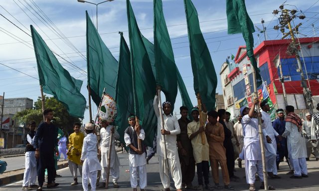 Devotees-carry-flags-in-a-procession-to-mark-12-Rabi-ul-Awwal-in-Karachi-on-Sunday.