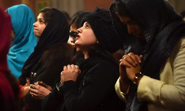 Christian devotees attend Christmas Day prayers at the Sacred Heart Church in Lahore