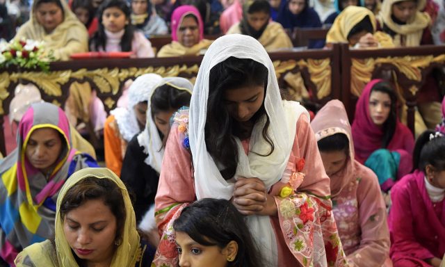 es attend Christmas Day prayers at St. Johns Cathedral Church in Peshawar on December 25, 2019.