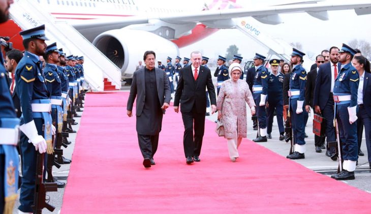Pakistan's Prime Minister Imran Khan walks with Turkish President Tayyip Erdogan on his arrival in Islamabad